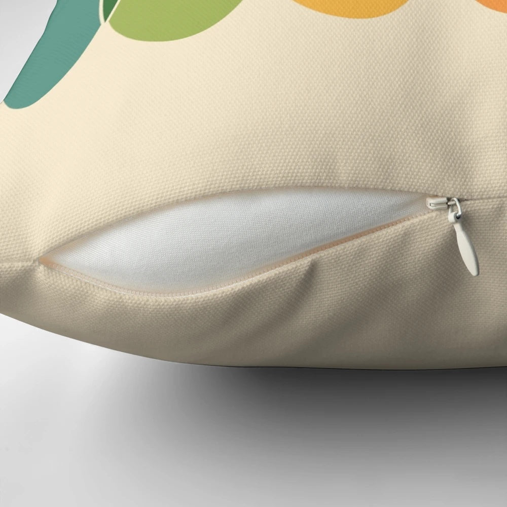 Colorful, geometric throw pillow with a horizontal pattern of overlapping ovals in a rainbow of colors.
