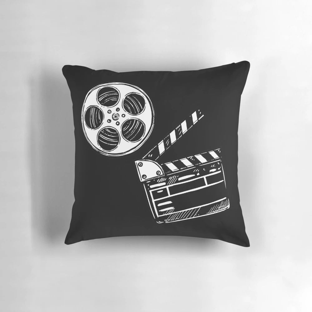 A colorful and whimsical movie-themed pillow featuring a clapperboard design, perfect for film enthusiasts and home decor.