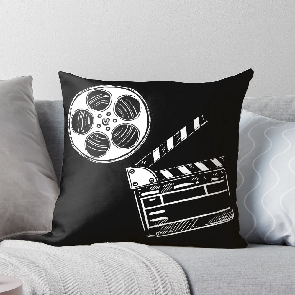 A colorful and whimsical movie-themed pillow featuring a clapperboard design, perfect for film enthusiasts and home decor.