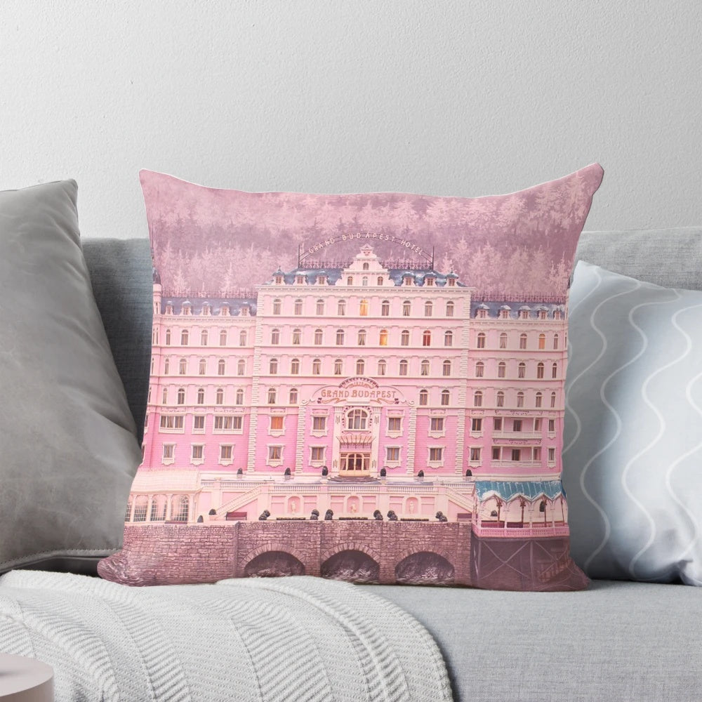 Decorative pillow featuring iconic scenes and characters from The Grand Budapest Hotel movie.