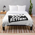 Plush blanket with movie clapperboard design and "And... Action!" text