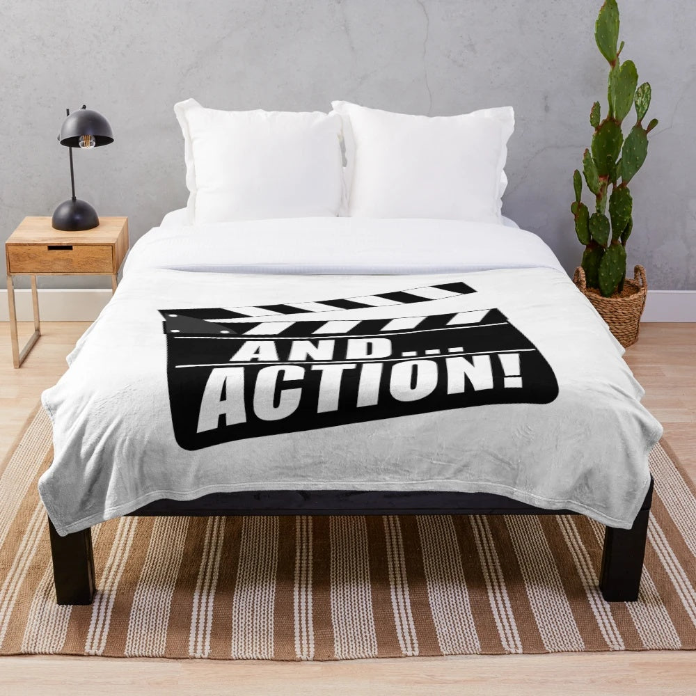 Plush blanket with movie clapperboard design and "And... Action!" text