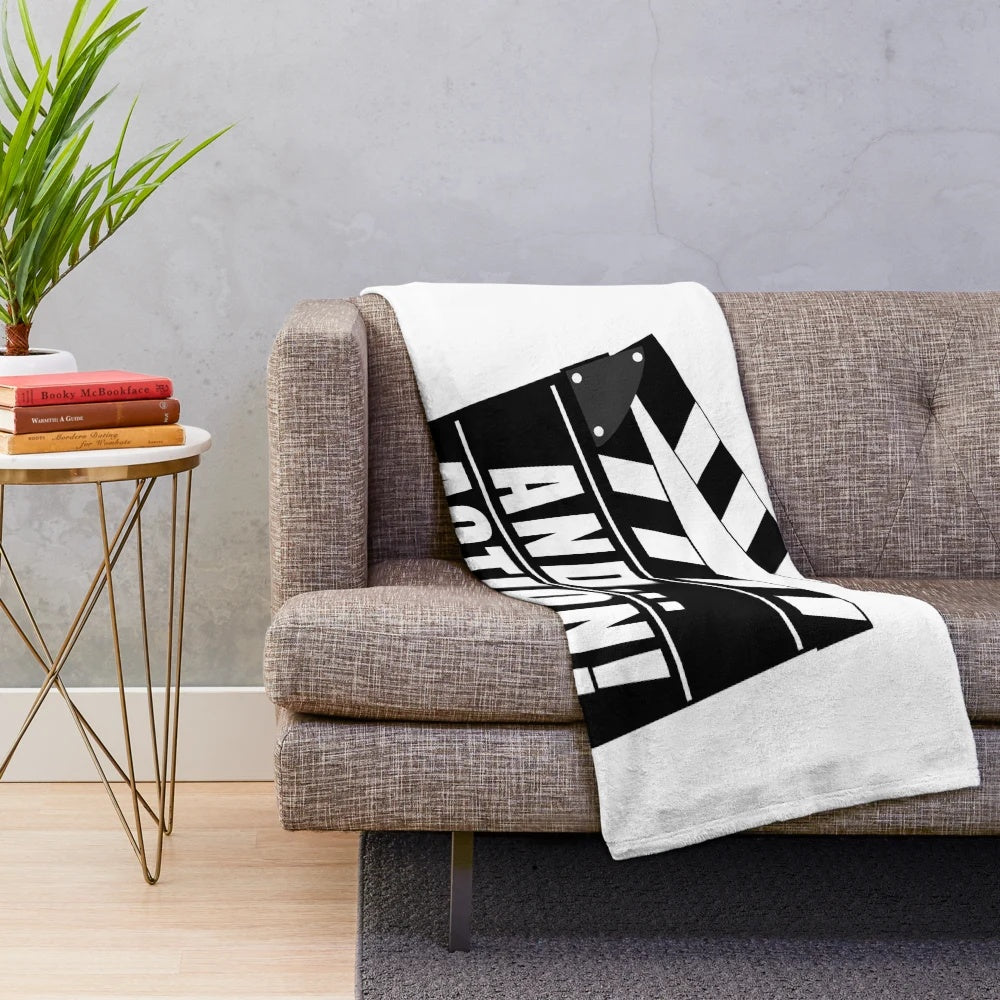 Plush blanket with movie clapperboard design and "And... Action!" text