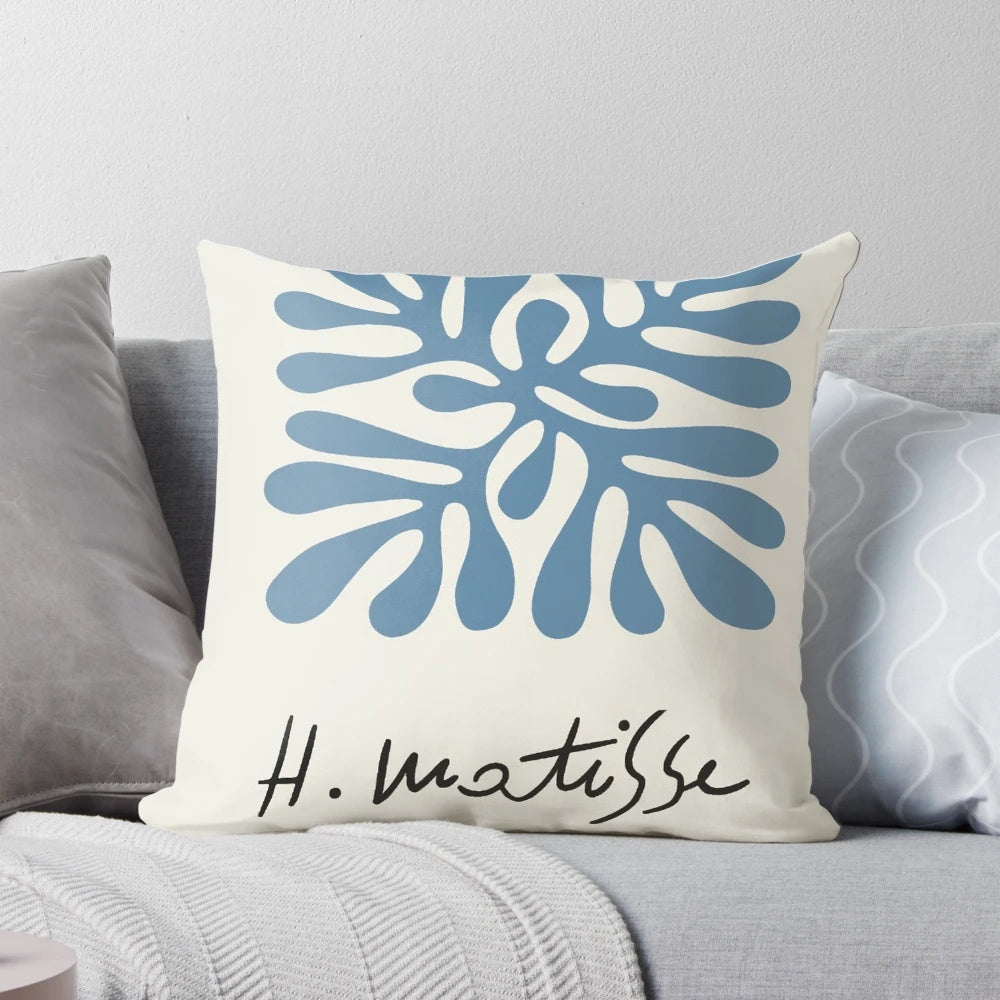 A decorative pillow featuring a classic henri matisse painting-inspired abstract woman artwork