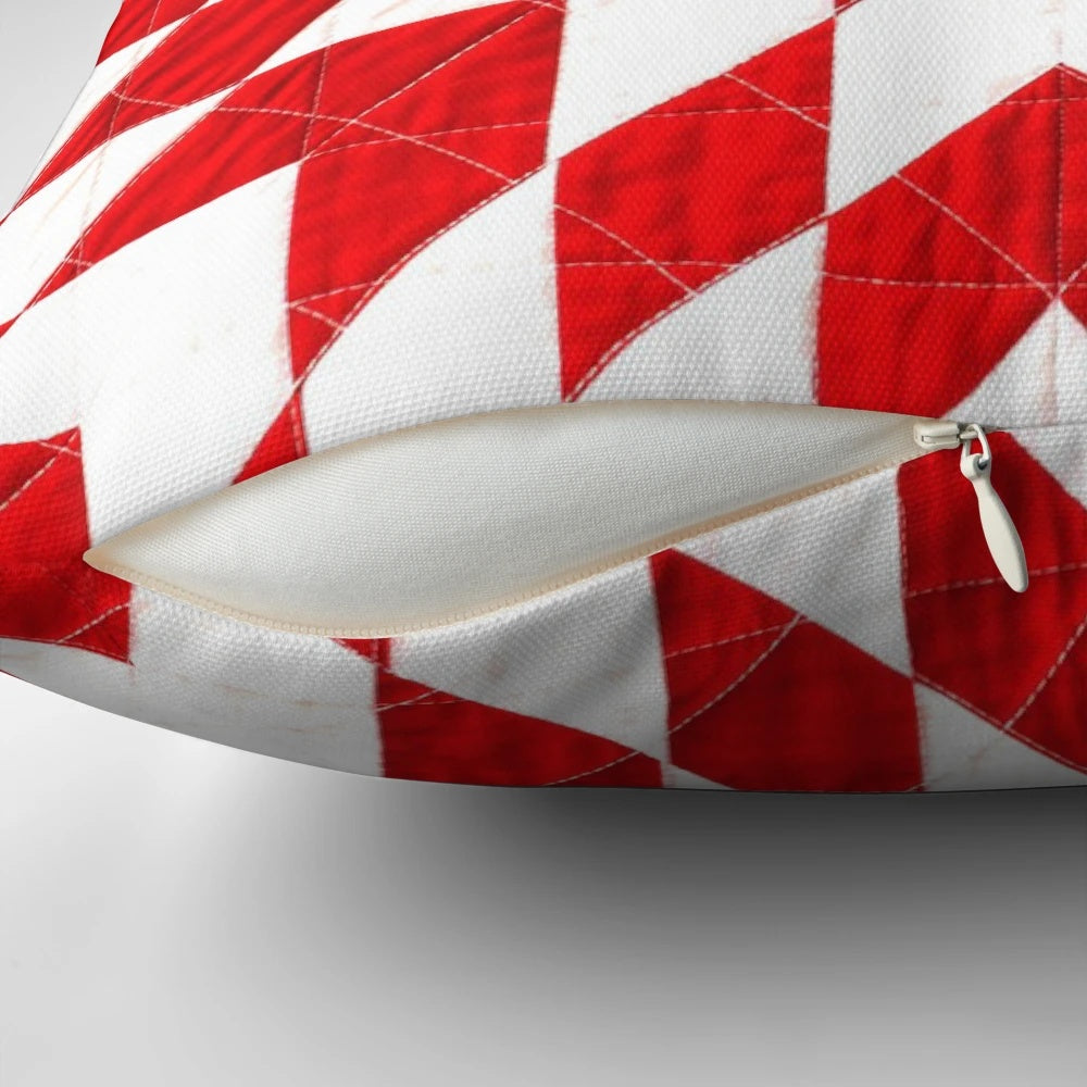 Close-up of a beautiful handmade red and white patchwork quilt pillow with a traditional lone star pattern.