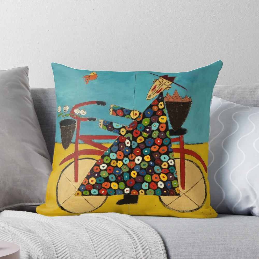 A colorful bicycle-themed pillow with a Buddhist monk design, perfect for coastal or beach-inspired decor.