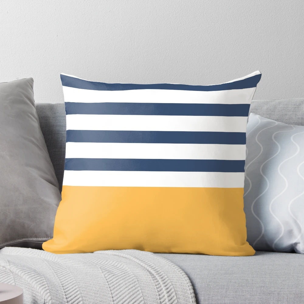 Blue and white striped decorative pillow with yellow geometric pattern, perfect for nautical or coastal home decor