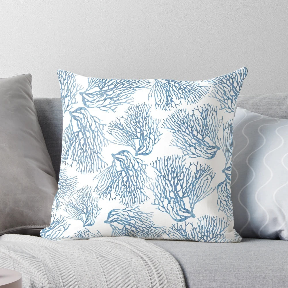 Decorative throw pillow featuring a watercolor-style blue sea fan coral pattern, perfect for coastal-inspired home decor.