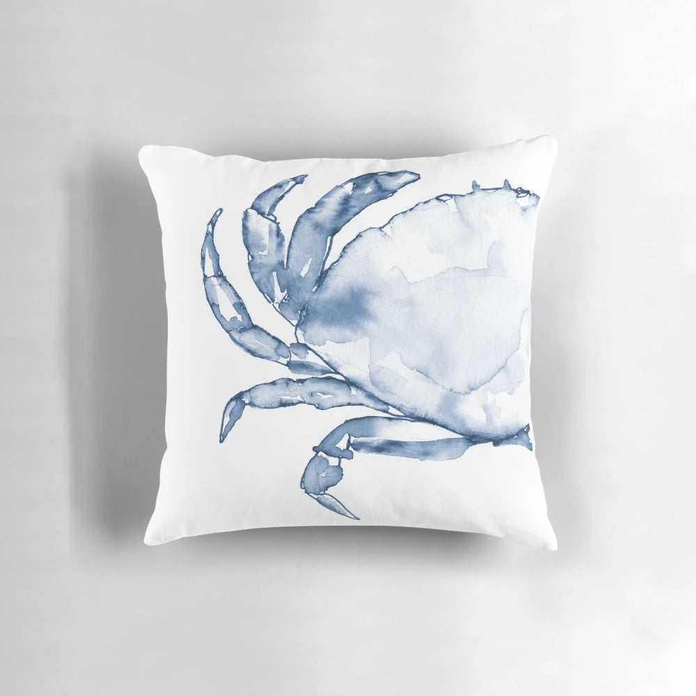 Coastal crab in watercolor art design on a navy blue throw pillow for beach-inspired home decor.