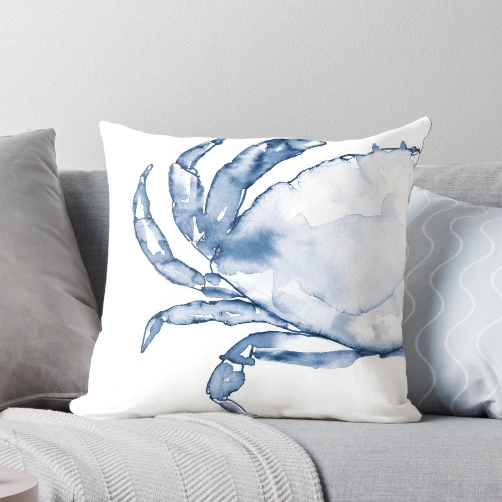 Coastal crab in watercolor art design on a navy blue throw pillow for beach-inspired home decor.