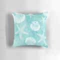 Coastal-inspired decorative pillow with starfish, seashells, and turquoise colors
