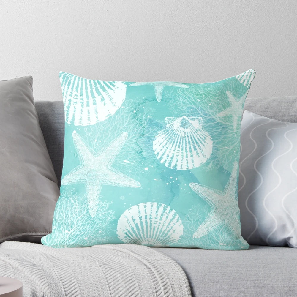 Coastal-inspired decorative pillow with starfish, seashells, and turquoise colors