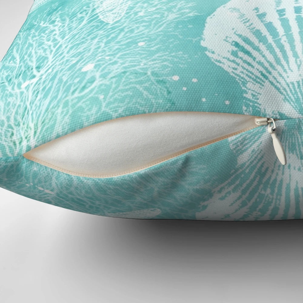 Coastal-inspired decorative pillow with starfish, seashells, and turquoise colors
