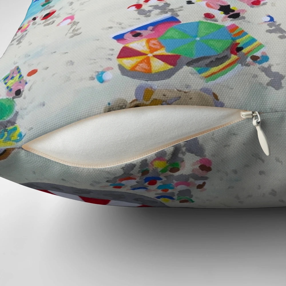 Coastal-inspired pillow featuring an aerial view of a beach and waves, designed by artist Stephanie Fuller