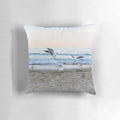 Decorative throw pillow featuring a scenic image of seagulls sitting on the beach