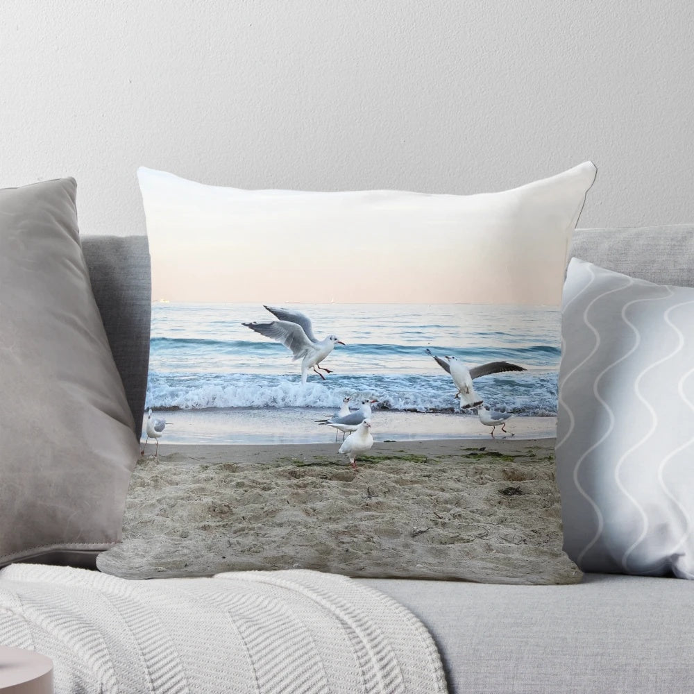 Decorative throw pillow featuring a scenic image of seagulls sitting on the beach
