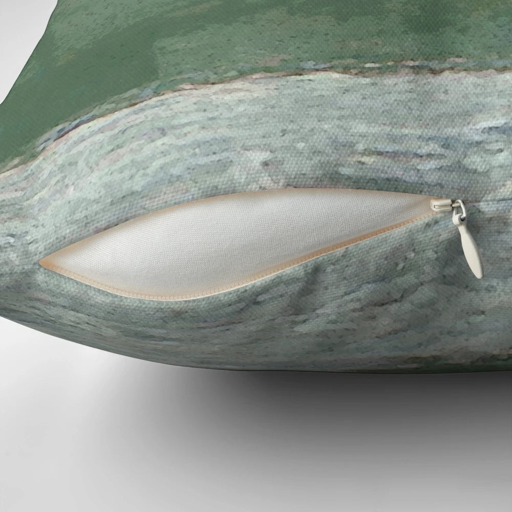 A decorative pillow featuring a design of shorebirds perched on rocky coastal landscape.