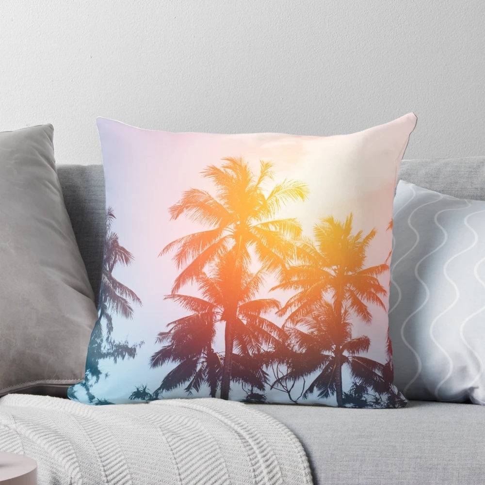 Coastal sunset pillow featuring a silhouette of palm trees against a colorful sky