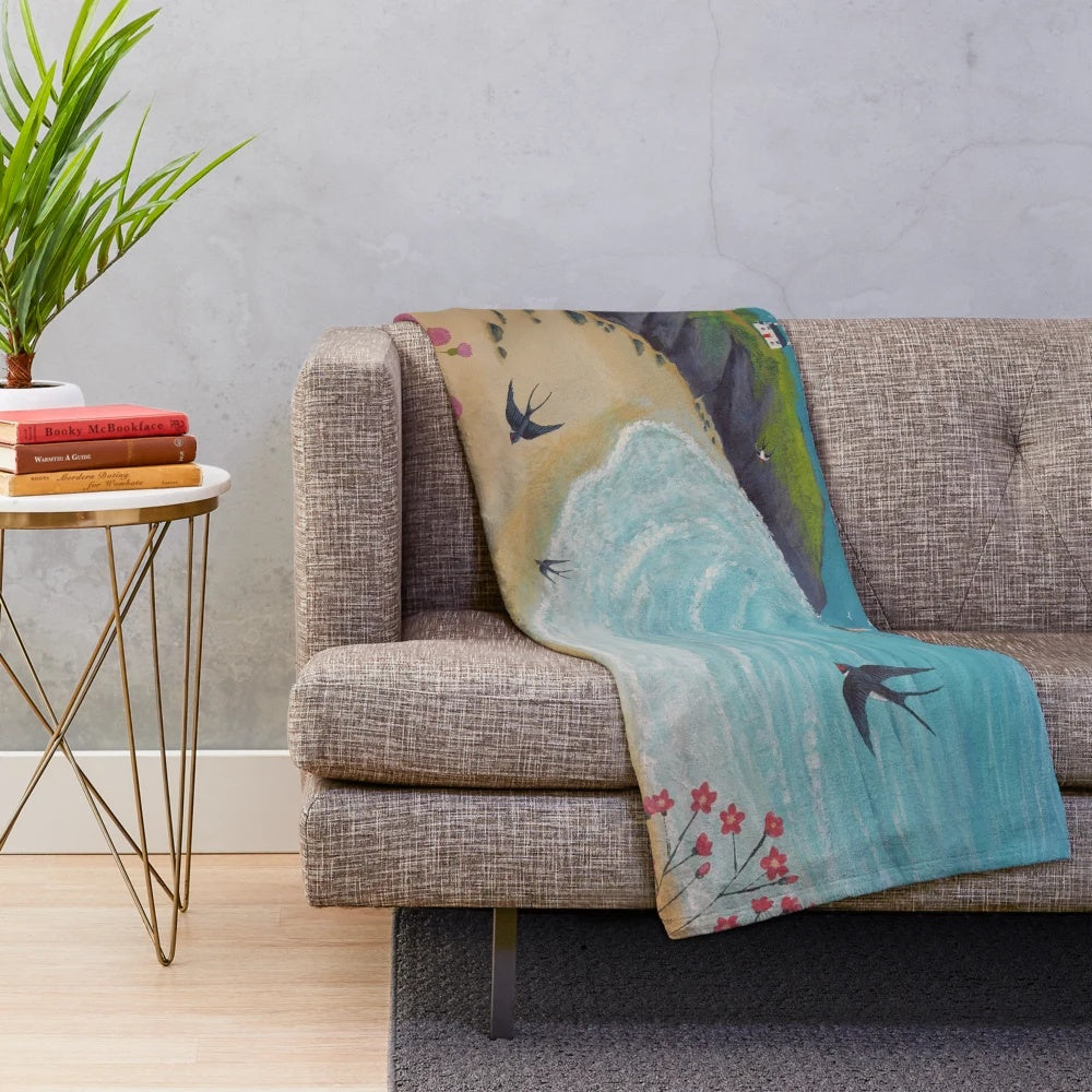 Coastal-themed plush blanket featuring swallows in a seaside landscape