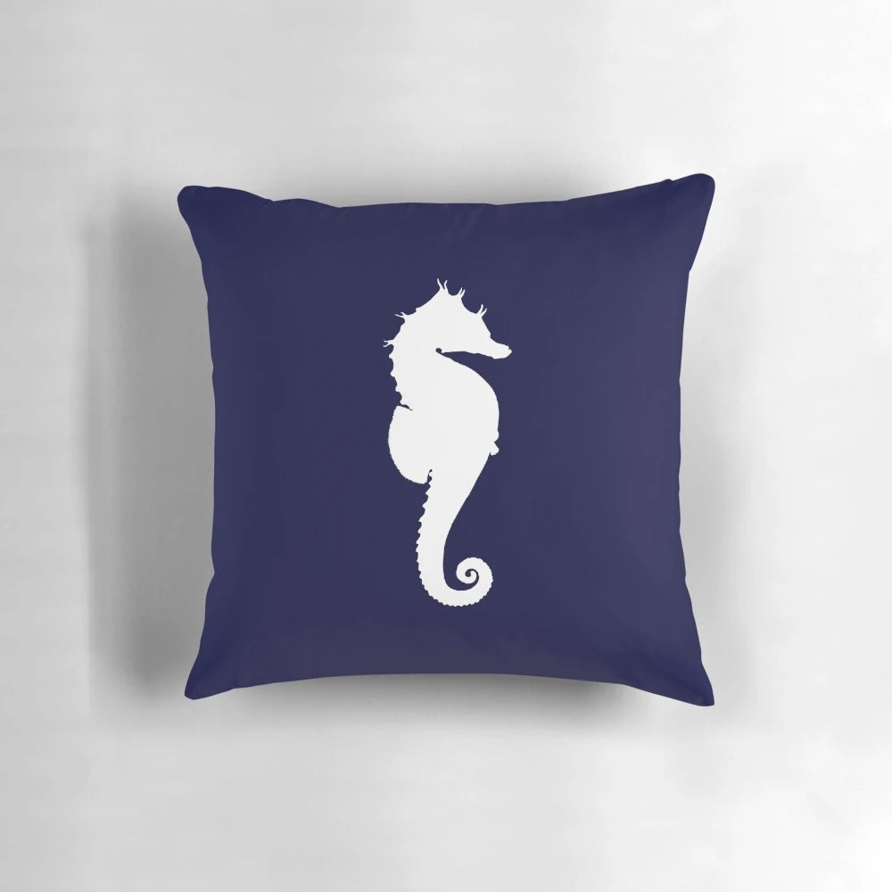 White seahorse silhouette on a navy blue decorative pillow