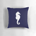 White seahorse silhouette on a navy blue decorative pillow