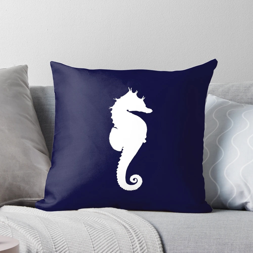 White seahorse silhouette on a navy blue decorative pillow