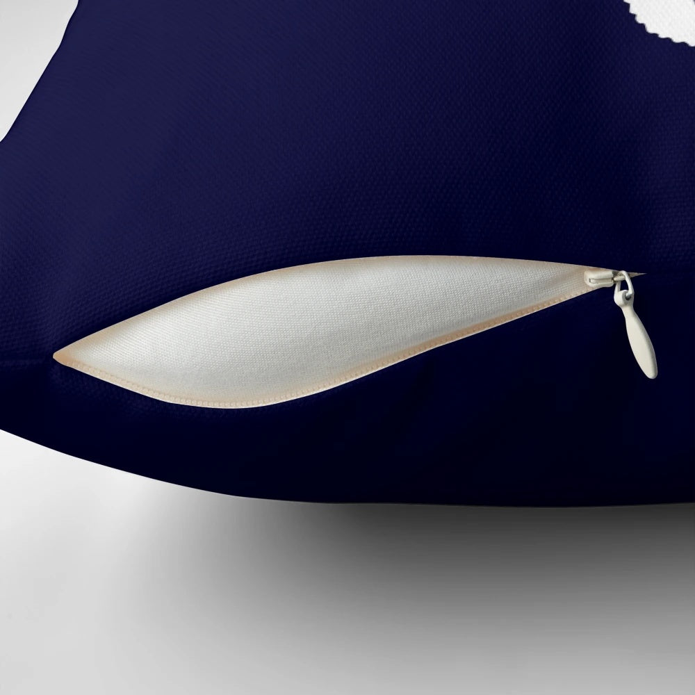 White seahorse silhouette on a navy blue decorative pillow