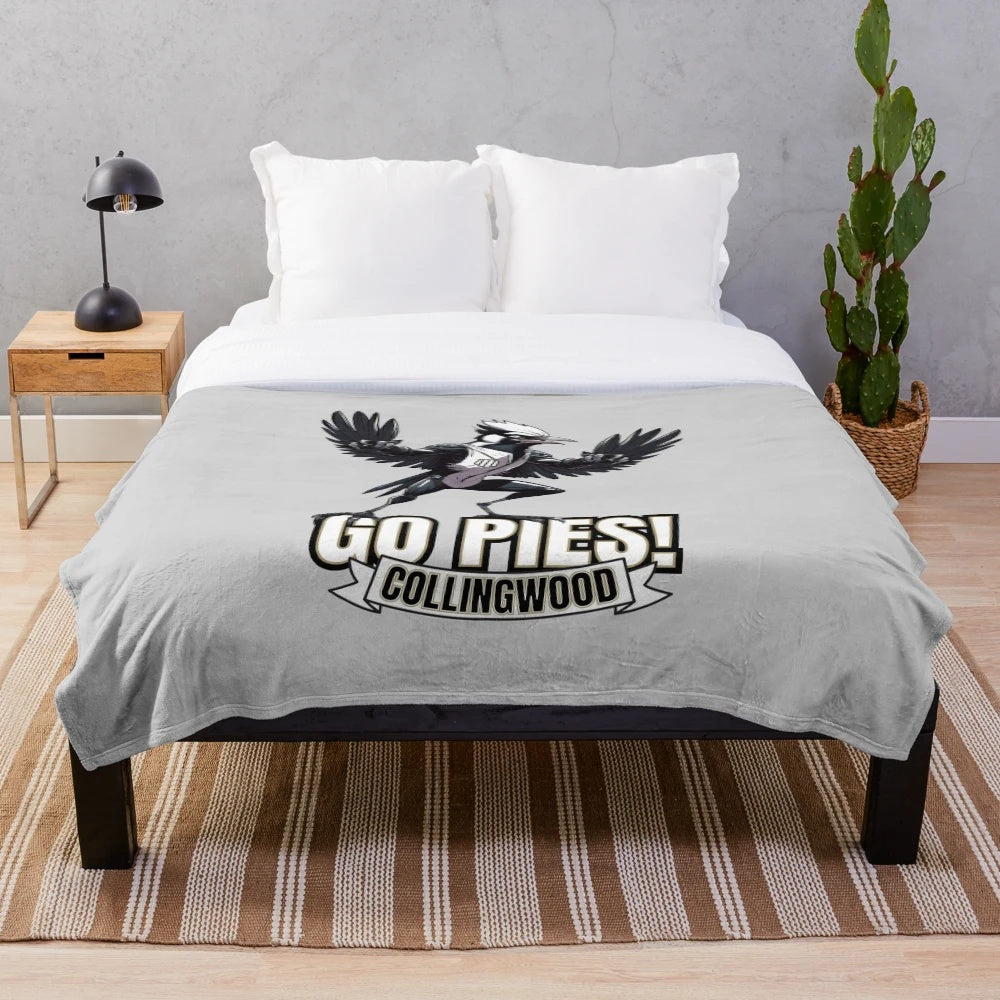 Collingwood Magpies plush blanket with team logo and colors