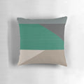 Colorblock pillow in earth tones of buff, cement, steel grey, charcoal, and emerald green