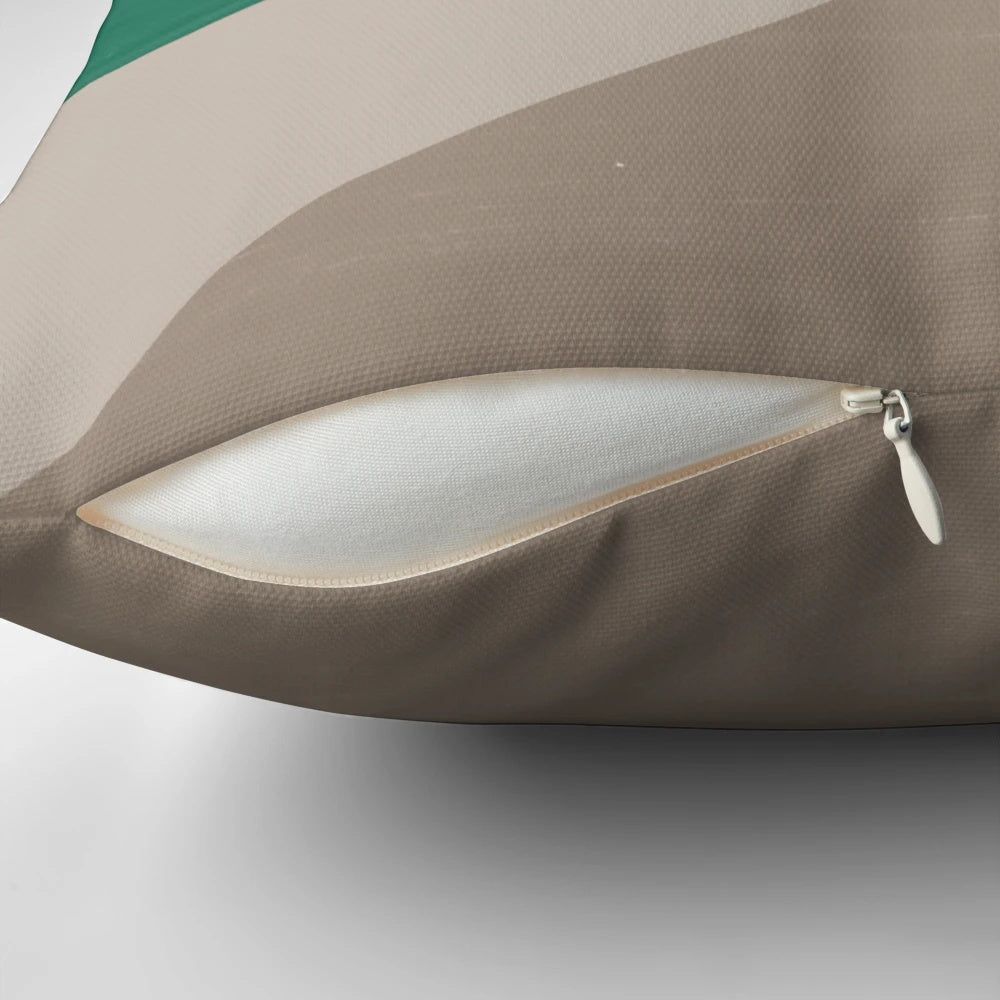 Colorblock pillow in earth tones of buff, cement, steel grey, charcoal, and emerald green