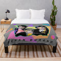 Vibrant 80s-style plush blanket with bold colors and retro music-inspired patterns