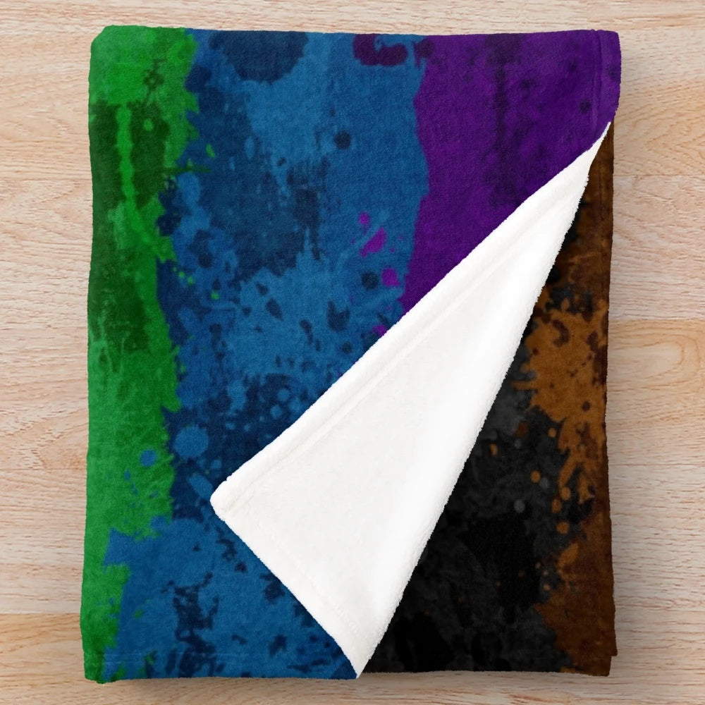 Colorful abstract paint splatter design on a plush, soft blanket with a rainbow pride flag motif