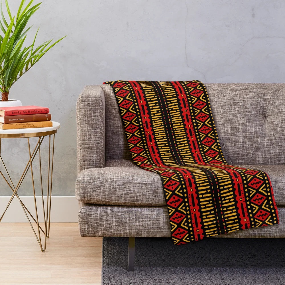 Vibrant red and yellow plush blanket with geometric African-inspired patterns