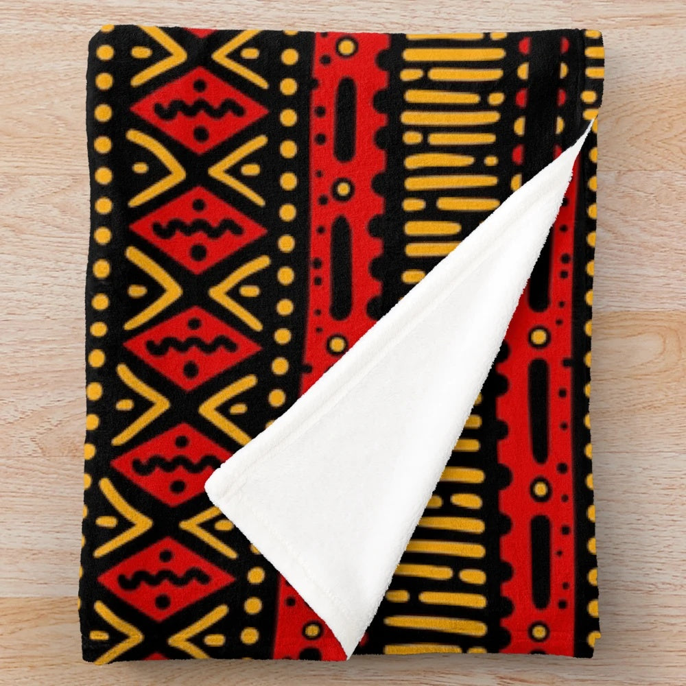 Vibrant red and yellow plush blanket with geometric African-inspired patterns