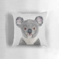 A colorful and whimsical pillow featuring a portrait of a baby koala bear against a nature-inspired backdrop.
