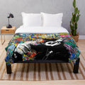 Colorful Banksy-inspired plush blanket featuring a monkey thinker urban art design