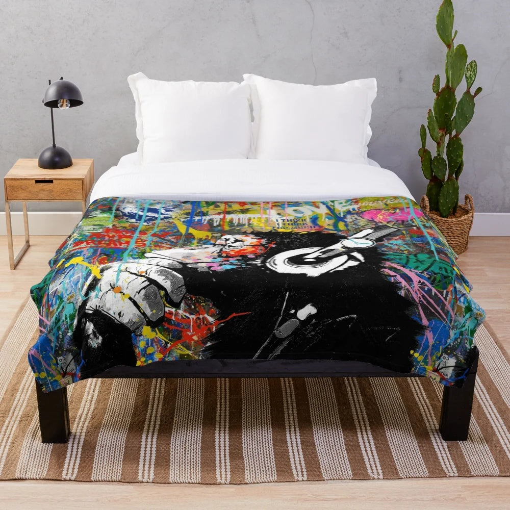 Colorful Banksy-inspired plush blanket featuring a monkey thinker urban art design