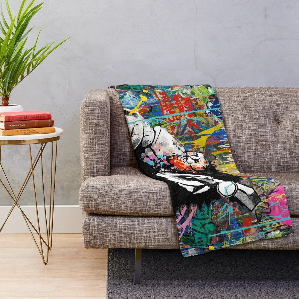 Colorful Banksy-inspired plush blanket featuring a monkey thinker urban art design