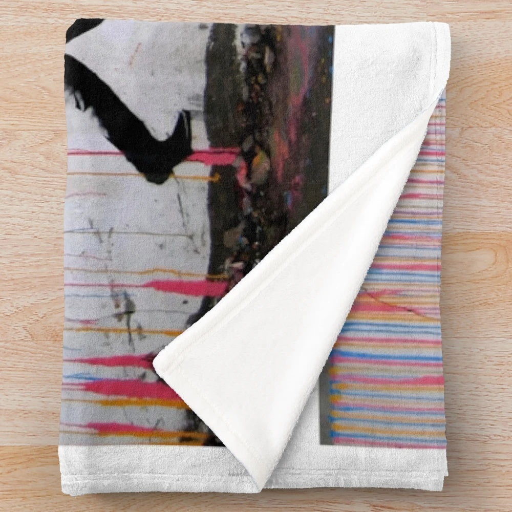 Cozy plush blanket featuring a vibrant, street art-inspired design of a girl with a rainbow umbrella