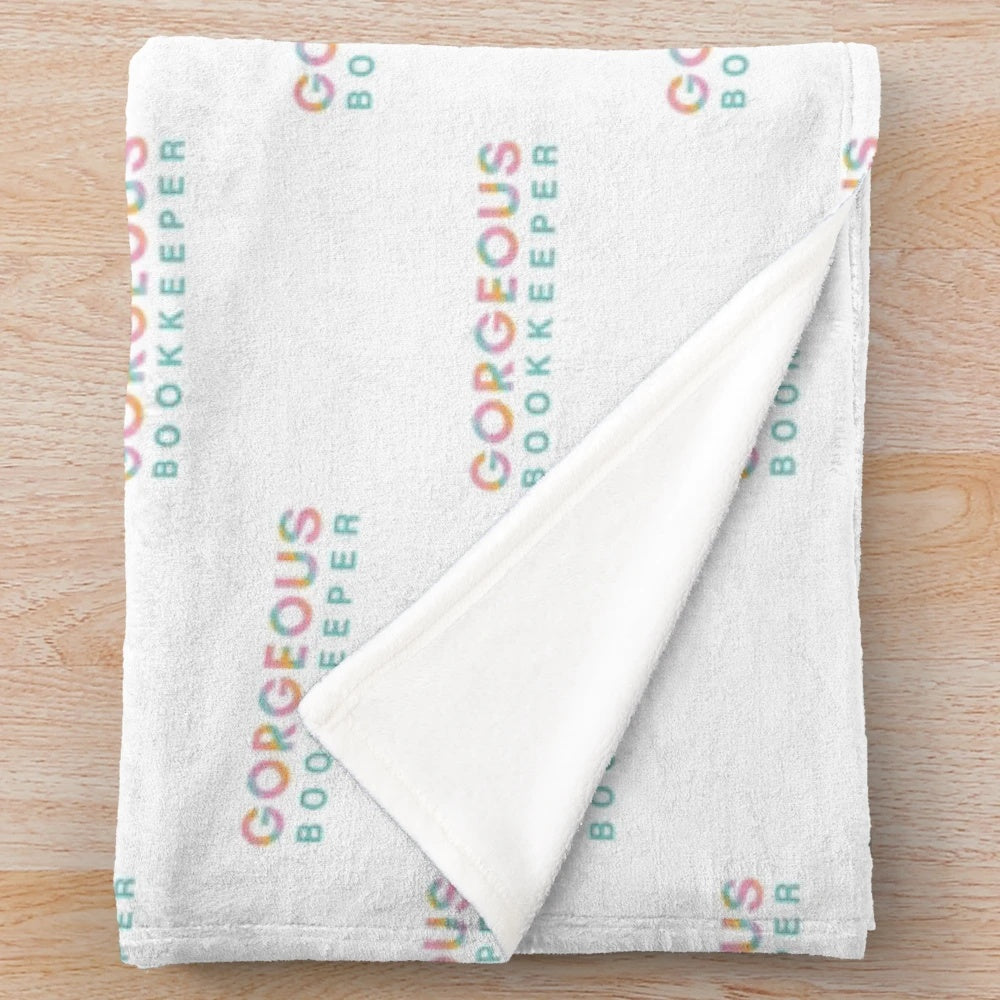 Colorful bookkeeper plush blanket with rainbow and pastel design