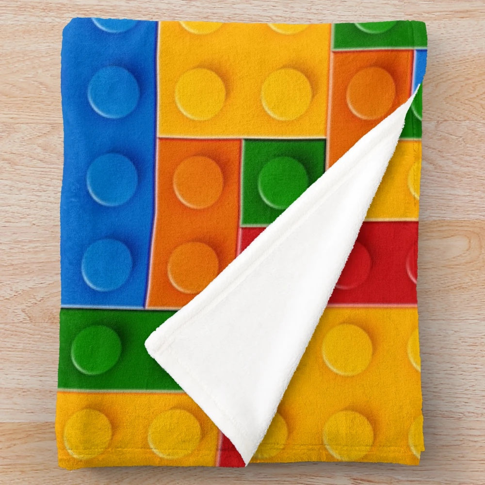 Plush blanket featuring colorful building blocks design
