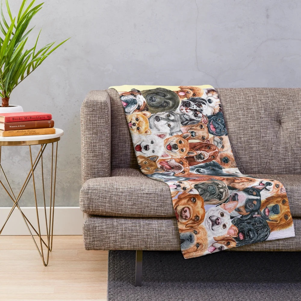 Colorful collage of painted dog faces on a plush blanket