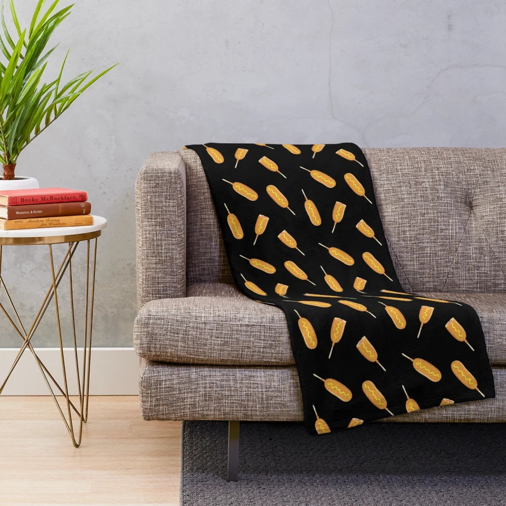 Plush blanket featuring a vibrant print of corn dogs on a stick