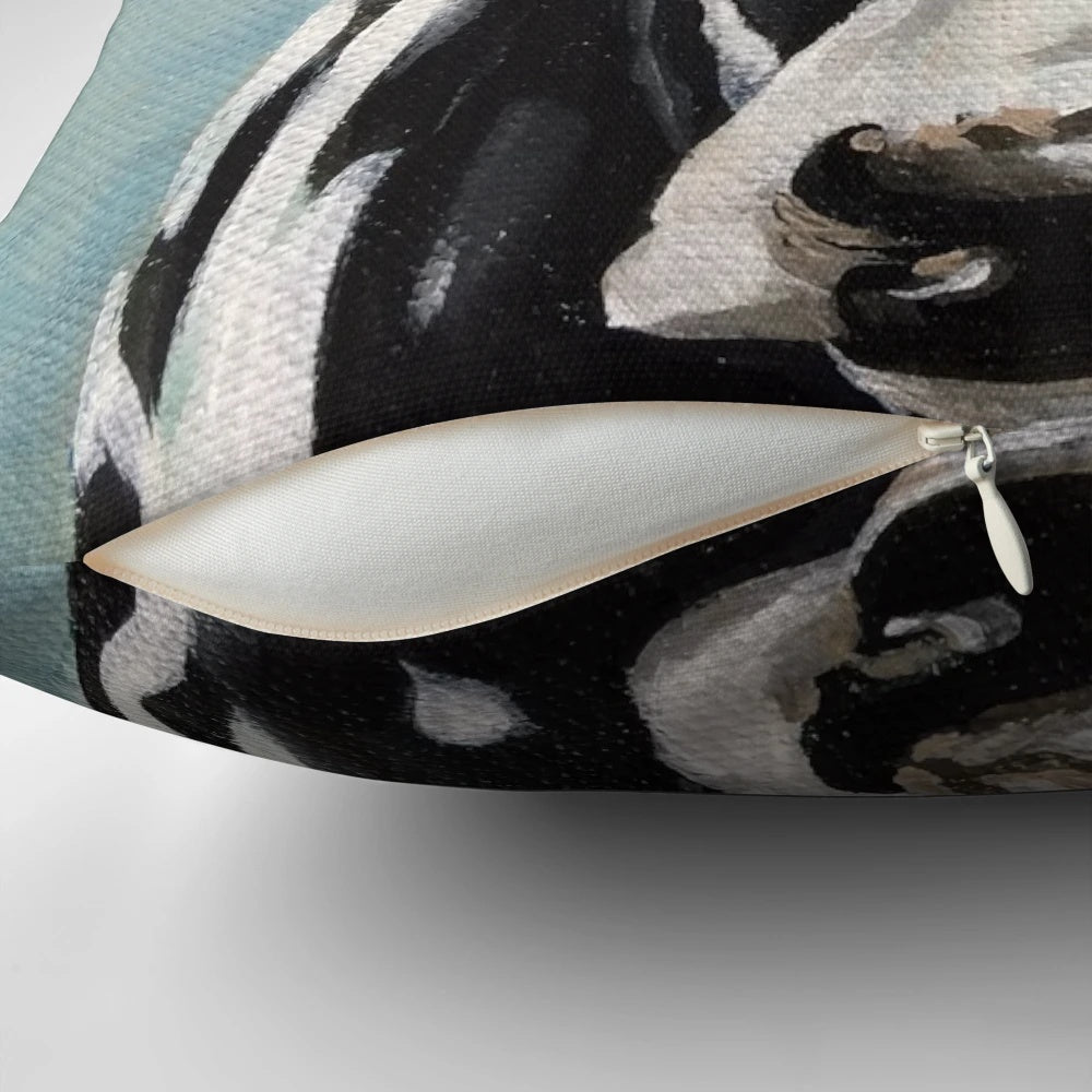 A vibrant black and white cow painting on a decorative throw pillow for farmhouse-style living spaces.