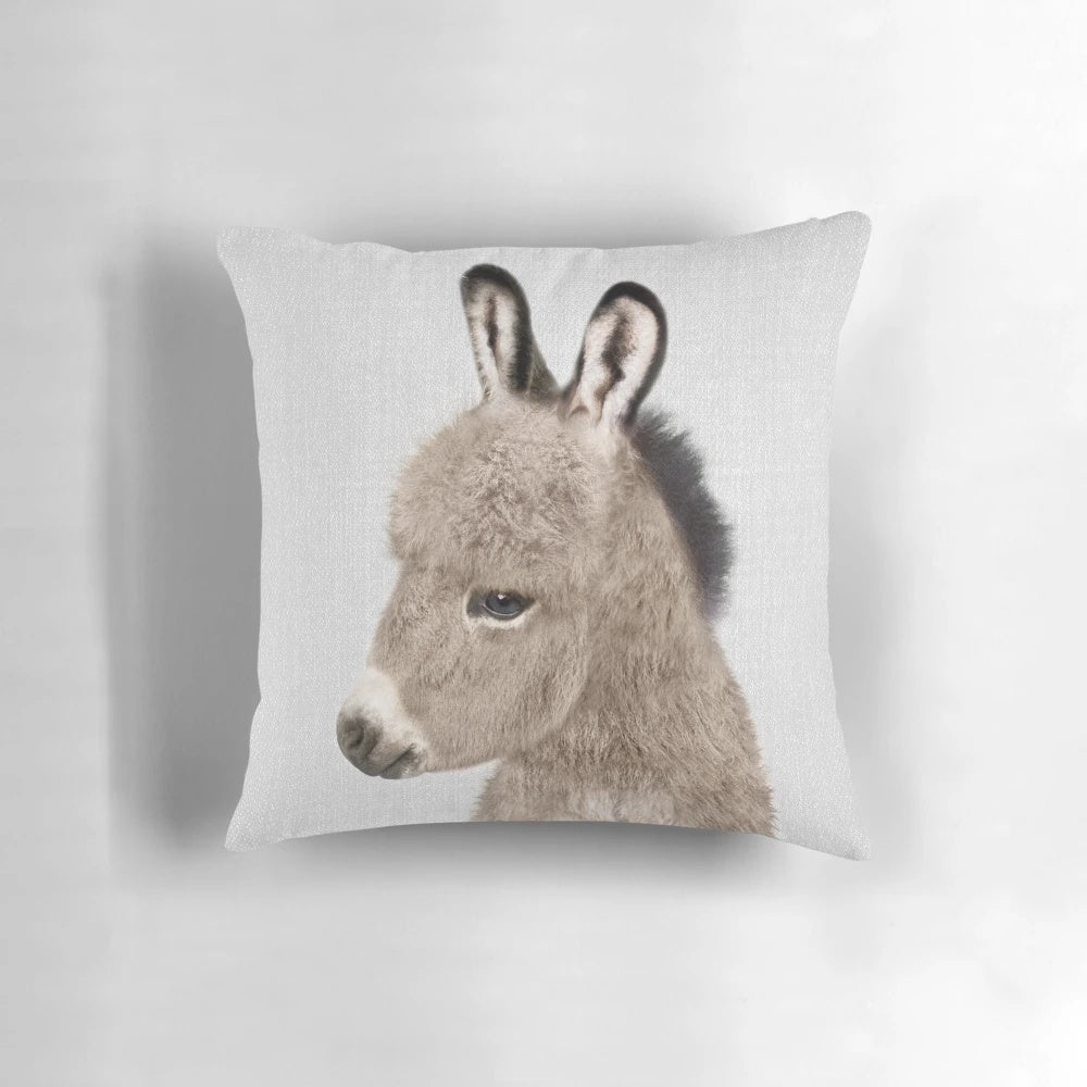 Colorful decorative pillow featuring an illustrated donkey design in a modern, minimalist style.