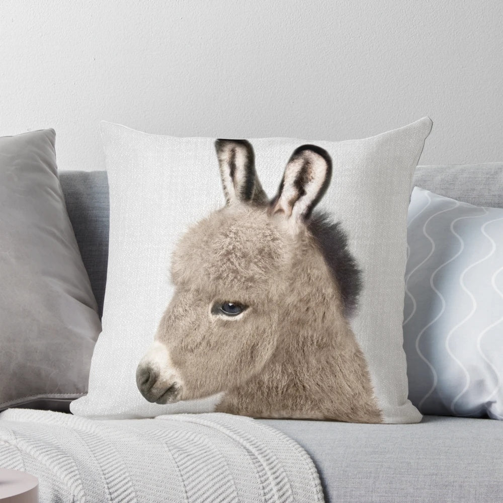 Colorful decorative pillow featuring an illustrated donkey design in a modern, minimalist style.