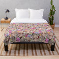 Colorful plush blanket featuring a pop art pattern of drag queens Trixie Mattel and Katya Zamolodchikova
