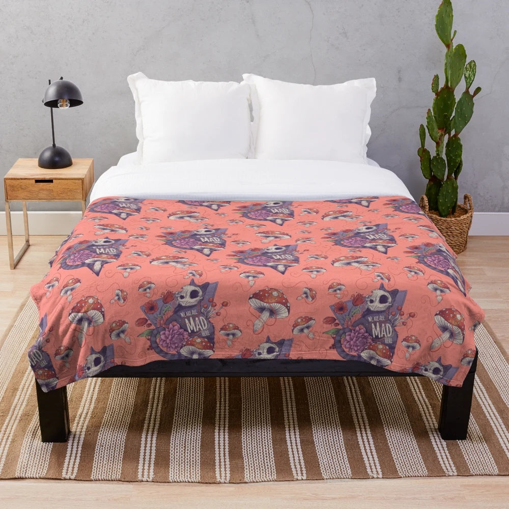 Colorful plush blanket featuring an Alice in Wonderland inspired design with a cat and flowers