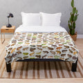 Plush blanket featuring a colorful illustration of 101 frog species found in Madagascar