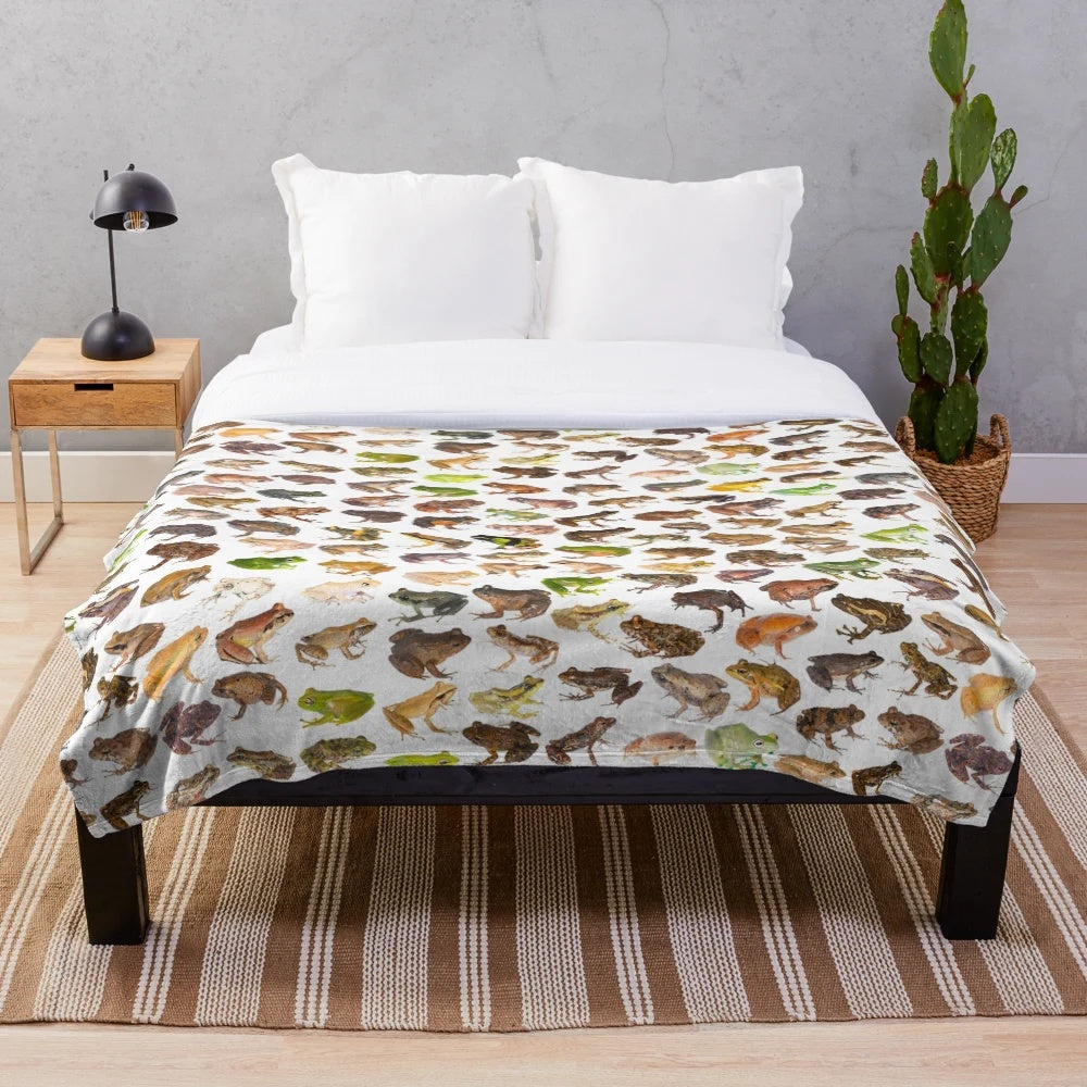 Plush blanket featuring a colorful illustration of 101 frog species found in Madagascar